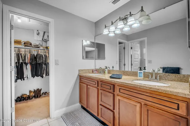 a bathroom with a sink double vanity and a mirror