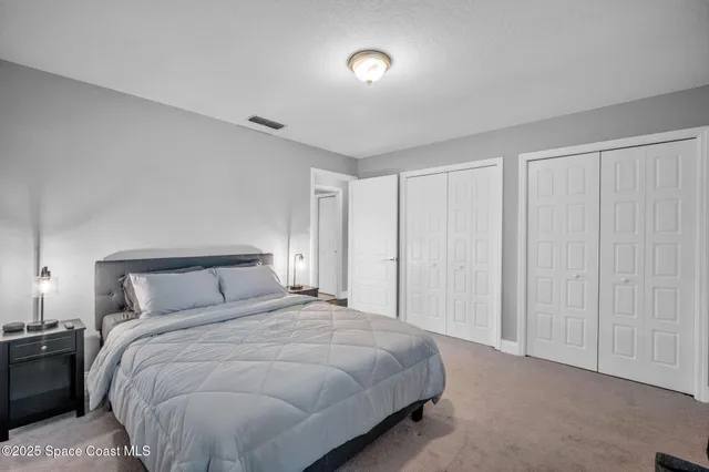 a bedroom with a bed and a night stand