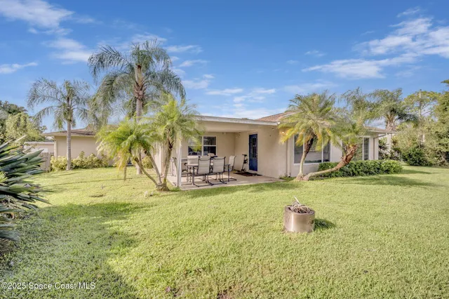 a view of a house with swimming pool and a yard