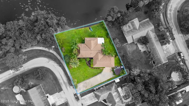 an aerial view of a house with outdoor space