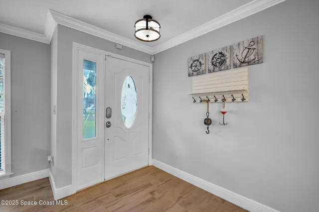 an empty room with wooden floor and mirror