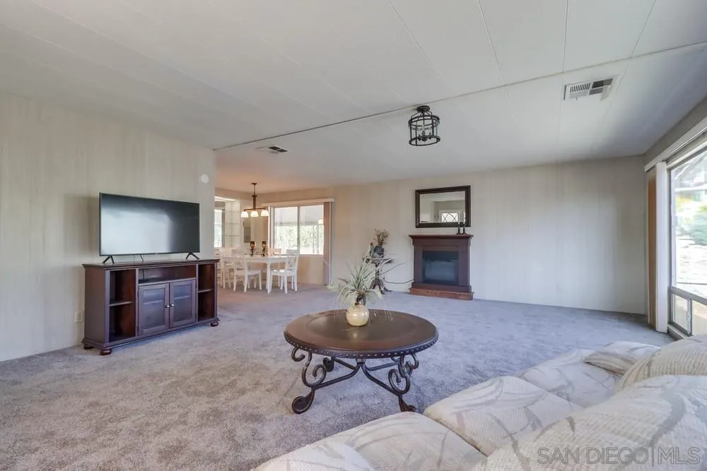 18218 Paradise Mountain Road, Unit 129 Valley Center, CA 92082 - Photo 11 of 58 a living room with furniture and a flat screen tv
