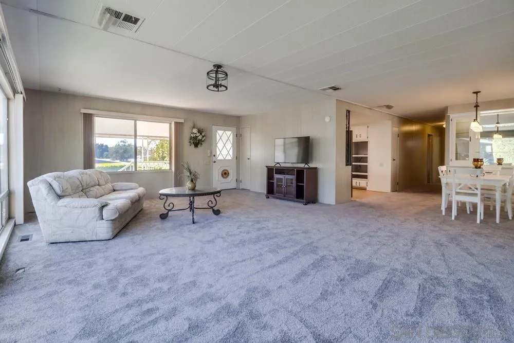 18218 Paradise Mountain Road, Unit 129 Valley Center, CA 92082 - Photo 12 of 58 a living room with furniture and a fireplace