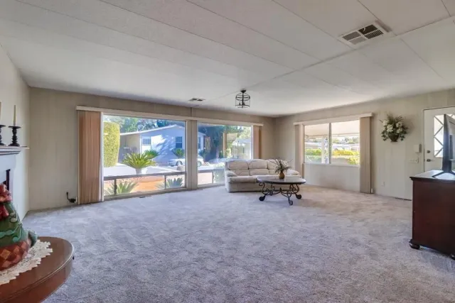 a kitchen with granite countertop stainless steel appliances a stove and a refrigerator