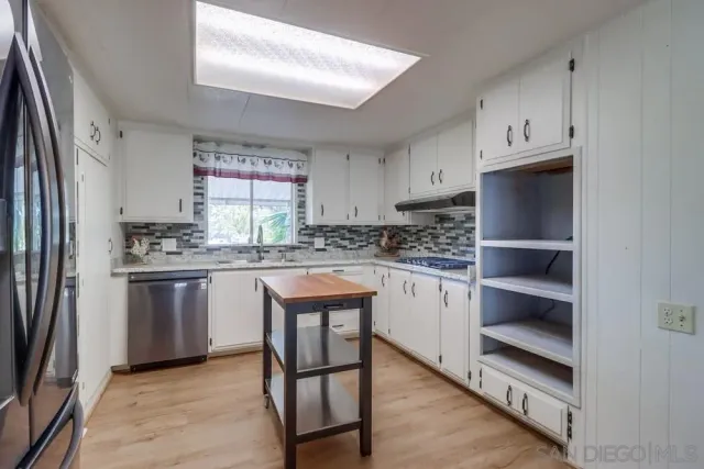 a kitchen with refrigerator and sink