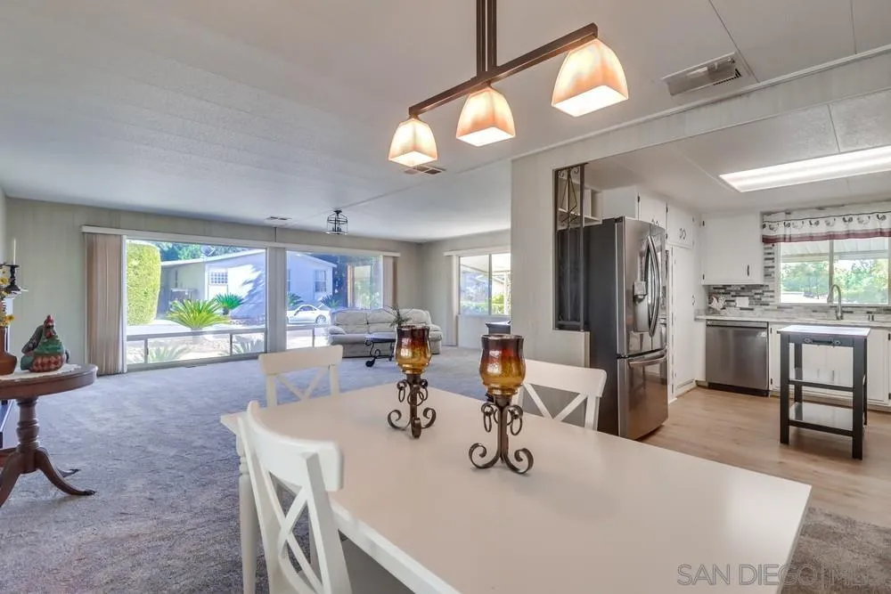 18218 Paradise Mountain Road, Unit 129 Valley Center, CA 92082 - Photo 18 of 58 a kitchen with refrigerator and sink