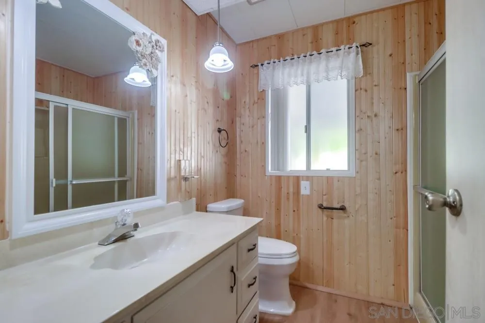 18218 Paradise Mountain Road, Unit 129 Valley Center, CA 92082 - Photo 20 of 58 a bathroom with a sink a toilet and shower