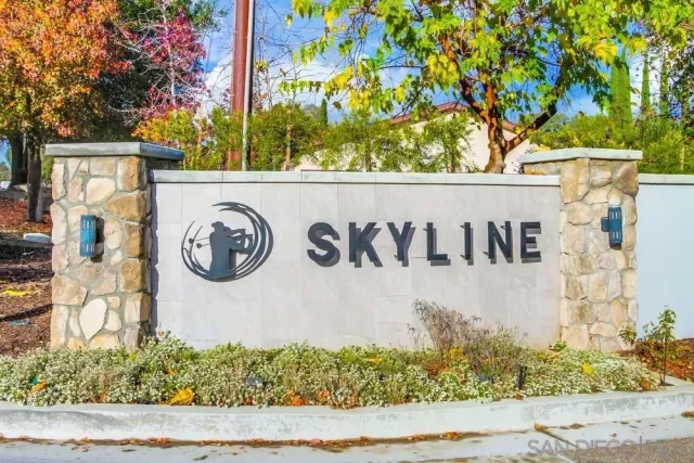 a view of a street sign under a large tree