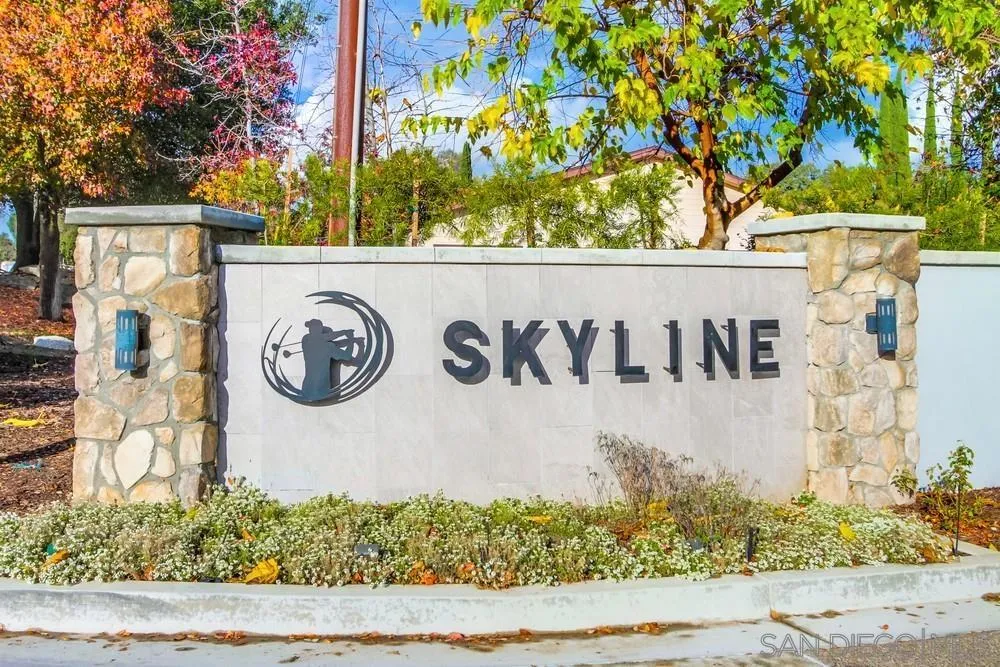 18218 Paradise Mountain Road, Unit 129 Valley Center, CA 92082 - Photo 2 of 58 a view of a street sign under a large tree