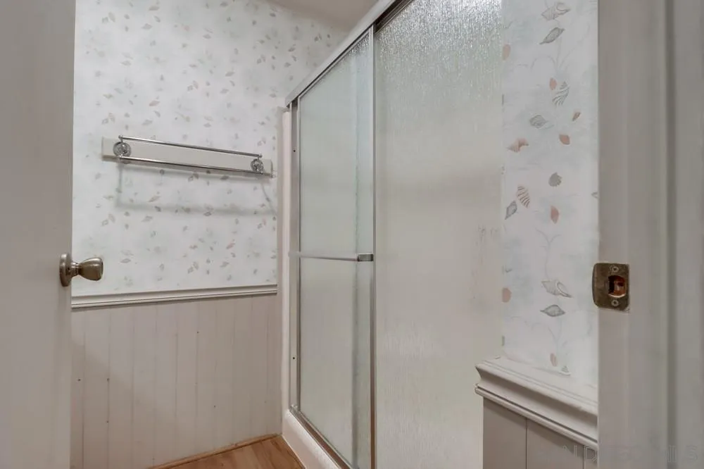 18218 Paradise Mountain Road, Unit 129 Valley Center, CA 92082 - Photo 31 of 58 a bathroom with a glass shower door