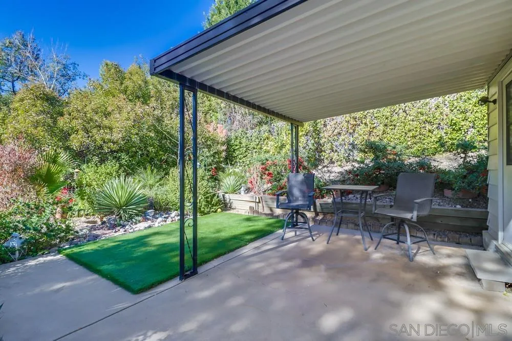 18218 Paradise Mountain Road, Unit 129 Valley Center, CA 92082 - Photo 39 of 58 a patio with table and chairs and couches with wooden fence