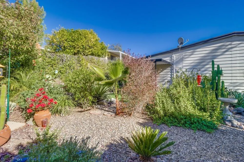 18218 Paradise Mountain Road, Unit 129 Valley Center, CA 92082 - Photo 44 of 58 a front view of a house with a yard