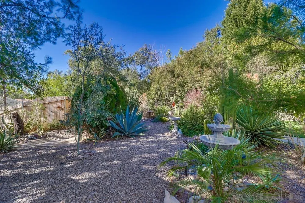 18218 Paradise Mountain Road, Unit 129 Valley Center, CA 92082 - Photo 45 of 58 a view of a yard with plants and large trees