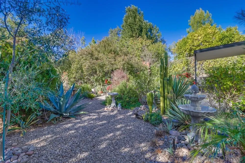 18218 Paradise Mountain Road, Unit 129 Valley Center, CA 92082 - Photo 46 of 58 a view of a plants with fountain in middle of the green field