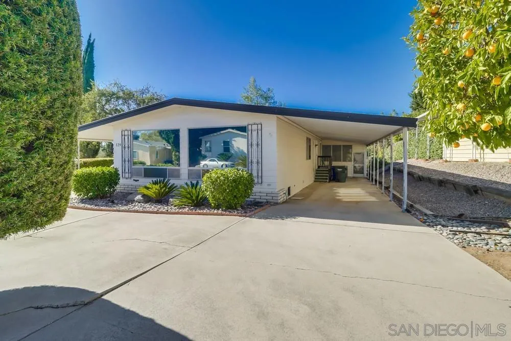 18218 Paradise Mountain Road, Unit 129 Valley Center, CA 92082 - Photo 5 of 58 a front view of a house with a yard