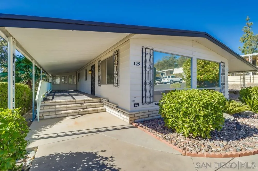 18218 Paradise Mountain Road, Unit 129 Valley Center, CA 92082 - Photo 6 of 58 a front view of a house with garden