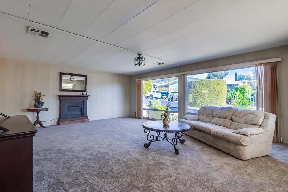 18218 Paradise Mountain Road, Unit 129 Valley Center, CA 92082 - Photo 10 of 58 a living room with furniture and a large window