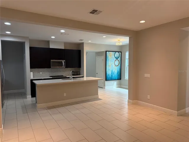 a large bathroom with a large mirror vanity and a sink