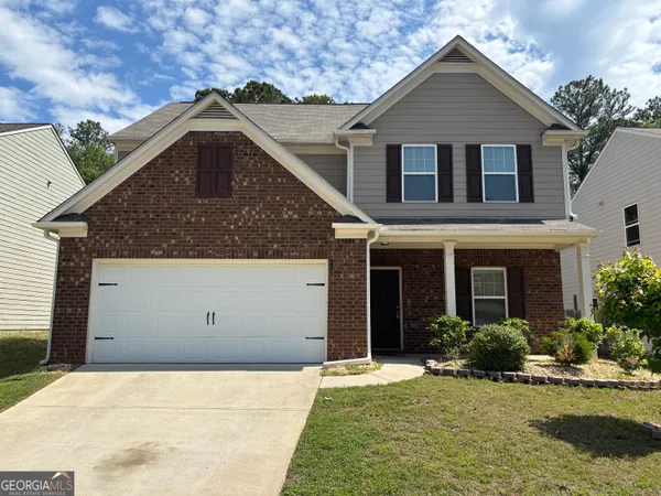 a front view of a house with a yard