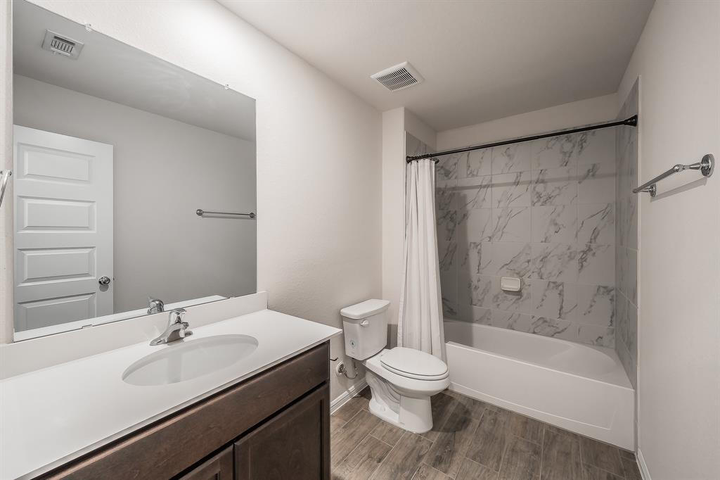 2727 Rambling Road Celina, TX 75009 - Photo 12 of 40 a bathroom with a sink toilet and shower