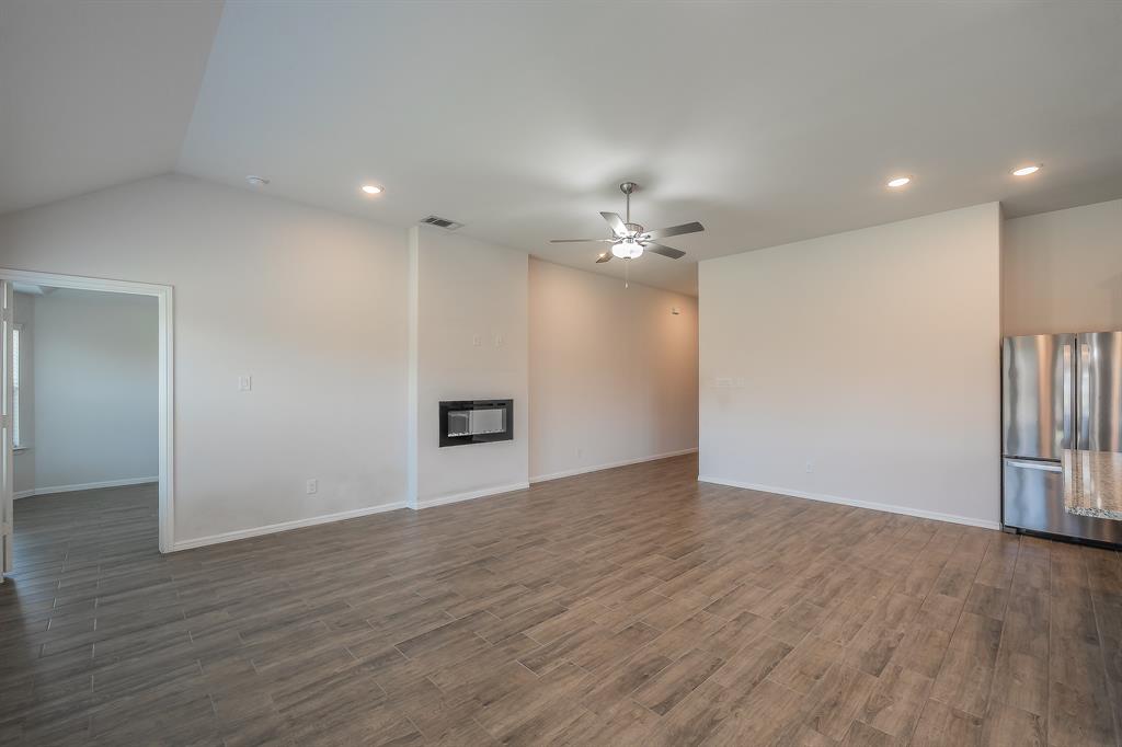 2727 Rambling Road Celina, TX 75009 - Photo 17 of 40 a view of an empty room with wooden floor