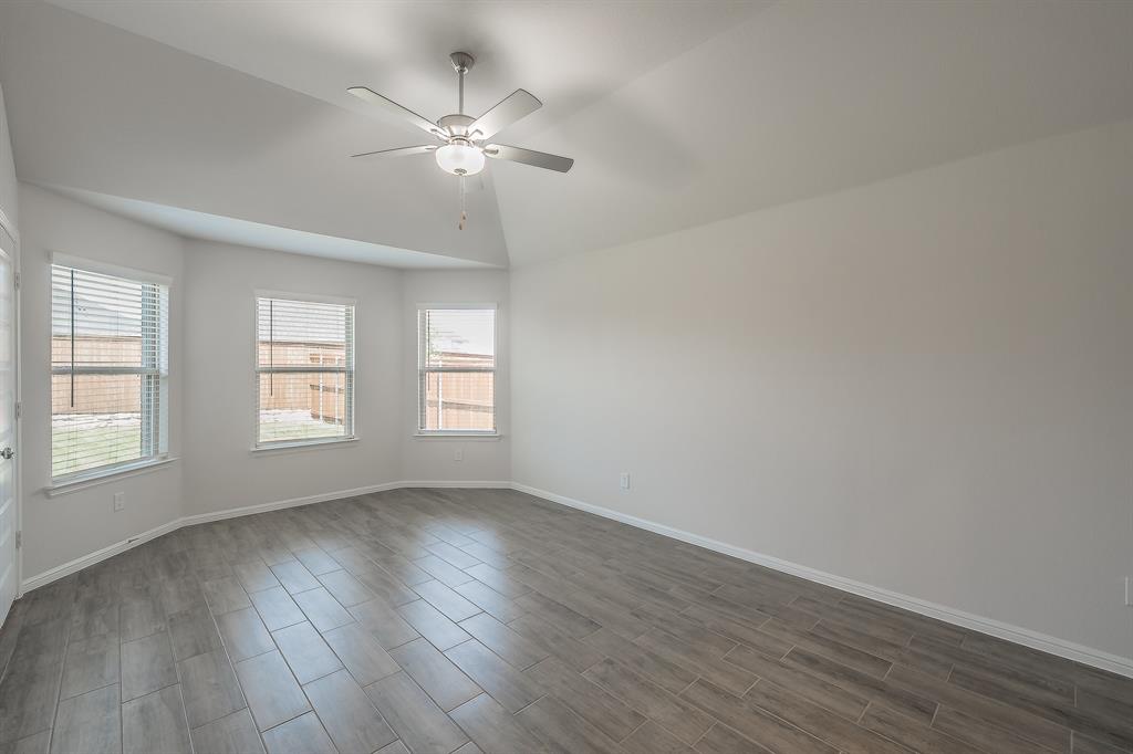 2727 Rambling Road Celina, TX 75009 - Photo 23 of 40 a view of an empty room with wooden floor and a window