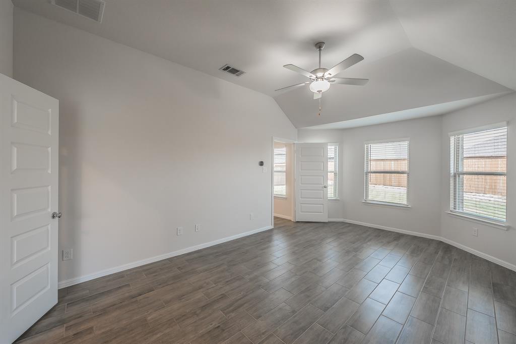 2727 Rambling Road Celina, TX 75009 - Photo 25 of 40 an empty room with wooden floor ceiling fan and windows