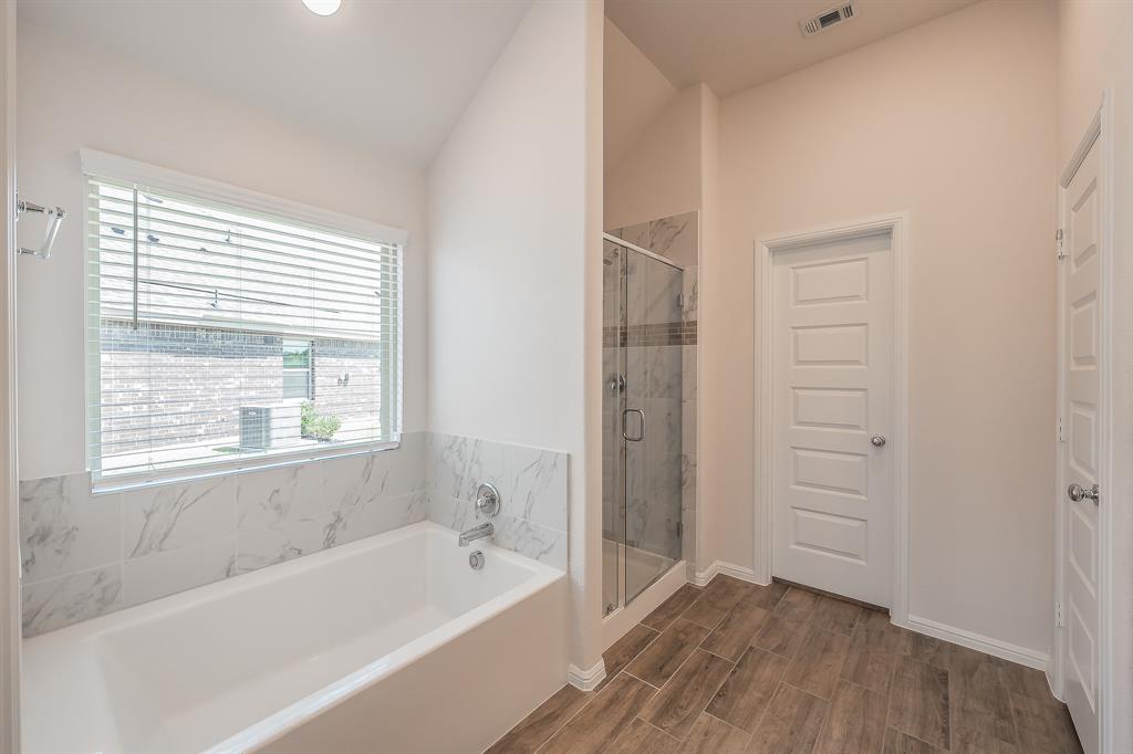 2727 Rambling Road Celina, TX 75009 - Photo 27 of 40 a bathroom with a bathtub and a shower