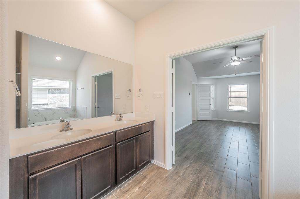 2727 Rambling Road Celina, TX 75009 - Photo 29 of 40 a bathroom with a sink and a mirror