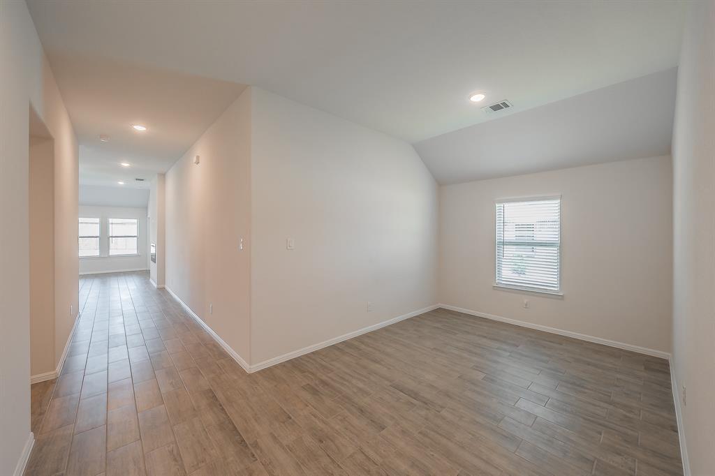 2727 Rambling Road Celina, TX 75009 - Photo 4 of 40 wooden floor in an empty room with a window