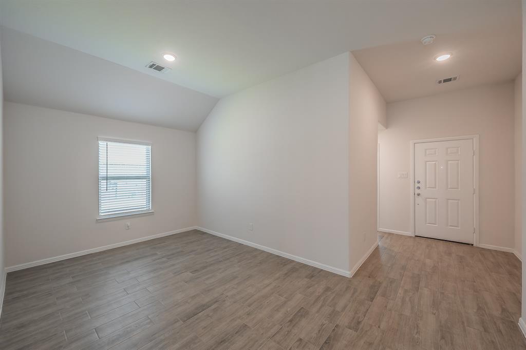 2727 Rambling Road Celina, TX 75009 - Photo 5 of 40 an empty room with wooden floor and window