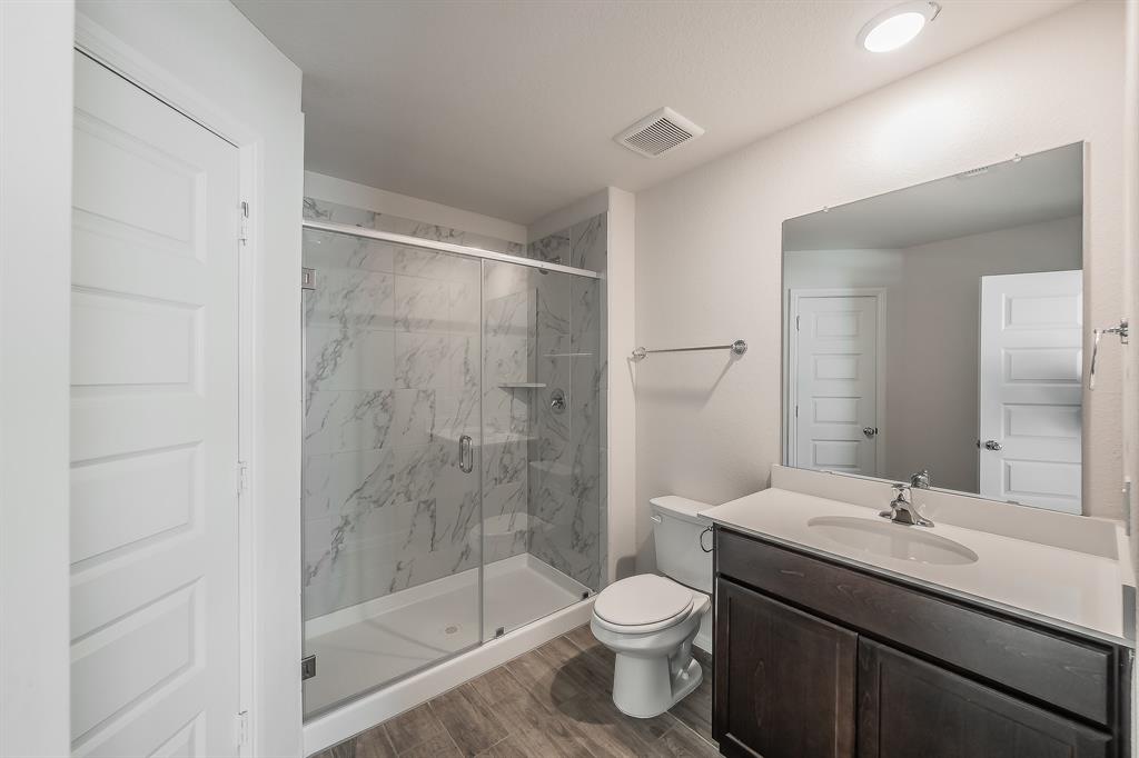 2727 Rambling Road Celina, TX 75009 - Photo 10 of 40 a bathroom with a sink a toilet and shower
