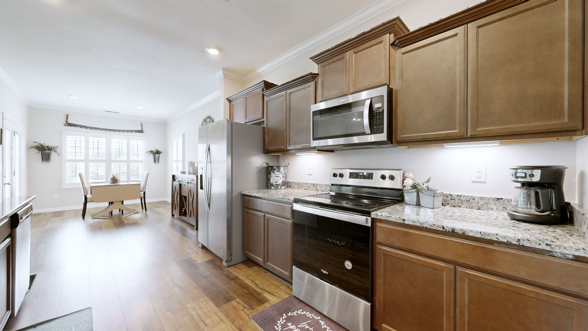 1047 Brayden Drive Fairview, TN 37062 - Photo 5 of 31 a kitchen with stainless steel appliances granite countertop wooden cabinets a stove top oven a sink and dishwasher