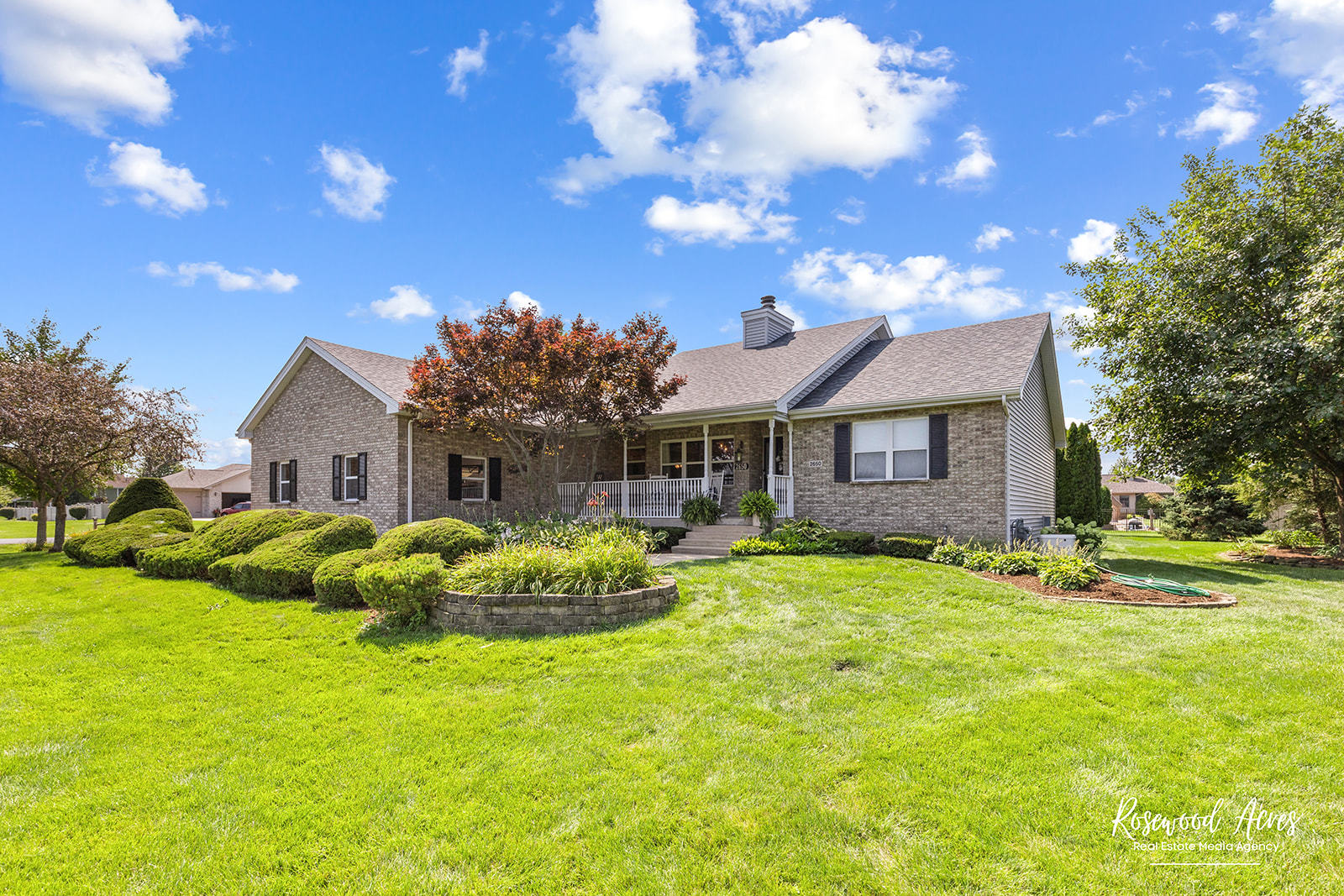 a front view of a house with a garden