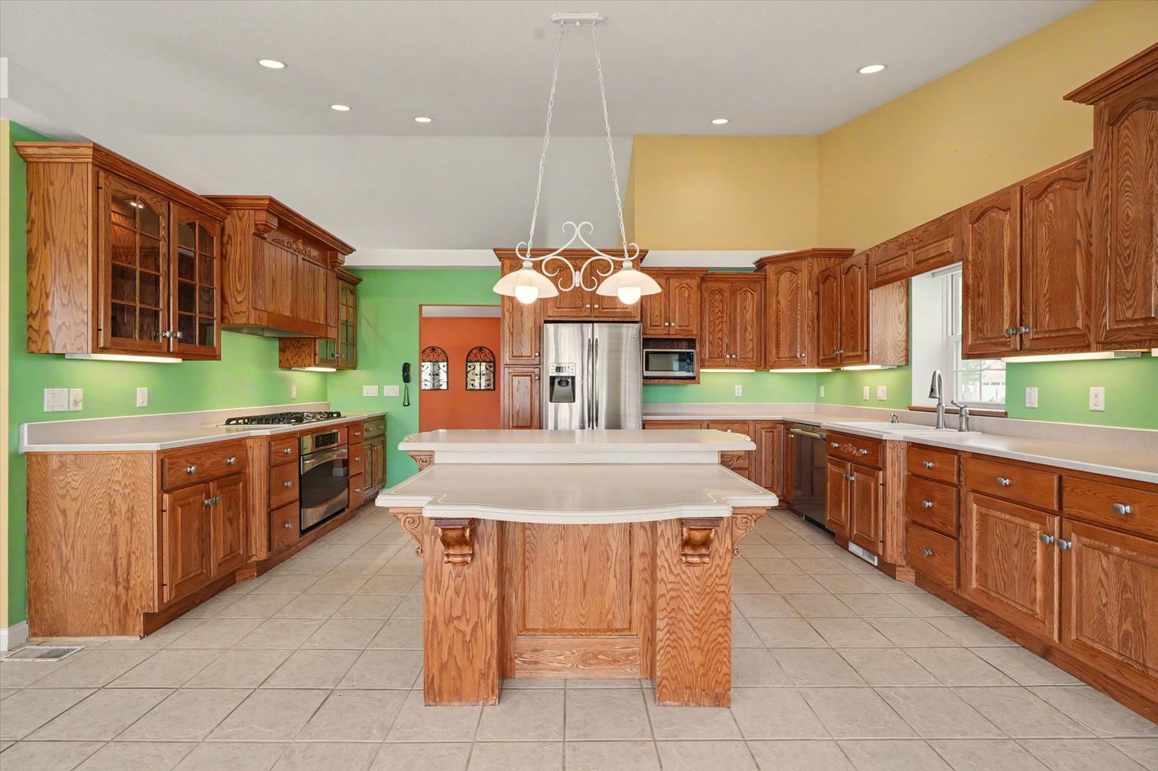 2910 Rutherford Drive Urbana, IL 61802 - Photo 17 of 62 a large kitchen with kitchen island granite countertop wooden cabinets and a sink