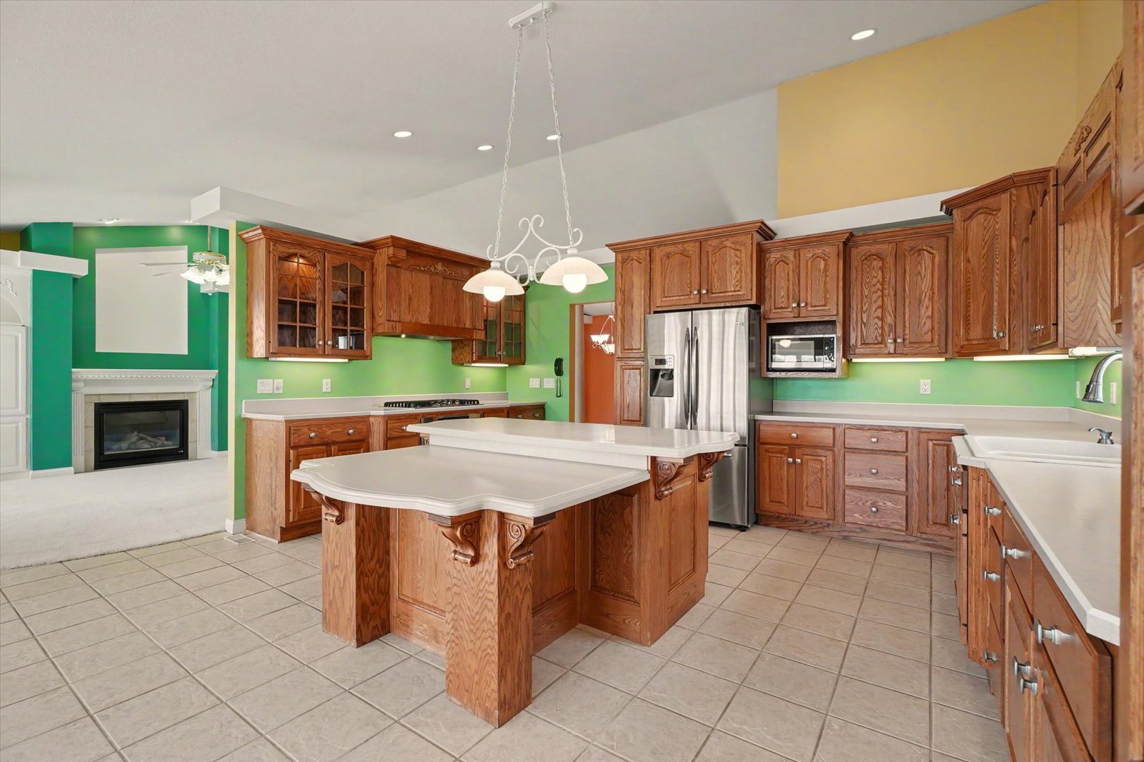 2910 Rutherford Drive Urbana, IL 61802 - Photo 18 of 62 a kitchen with stainless steel appliances kitchen island granite countertop a refrigerator a stove a sink and a oven with wooden cabinets