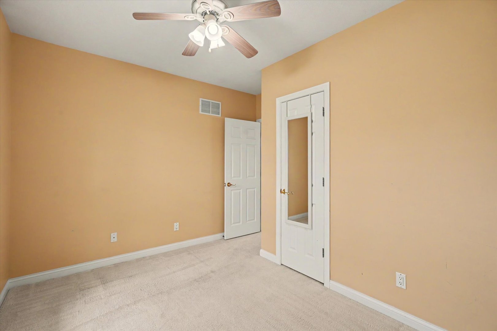 2910 Rutherford Drive Urbana, IL 61802 - Photo 30 of 62 an empty room with a chandelier fan and a glass door
