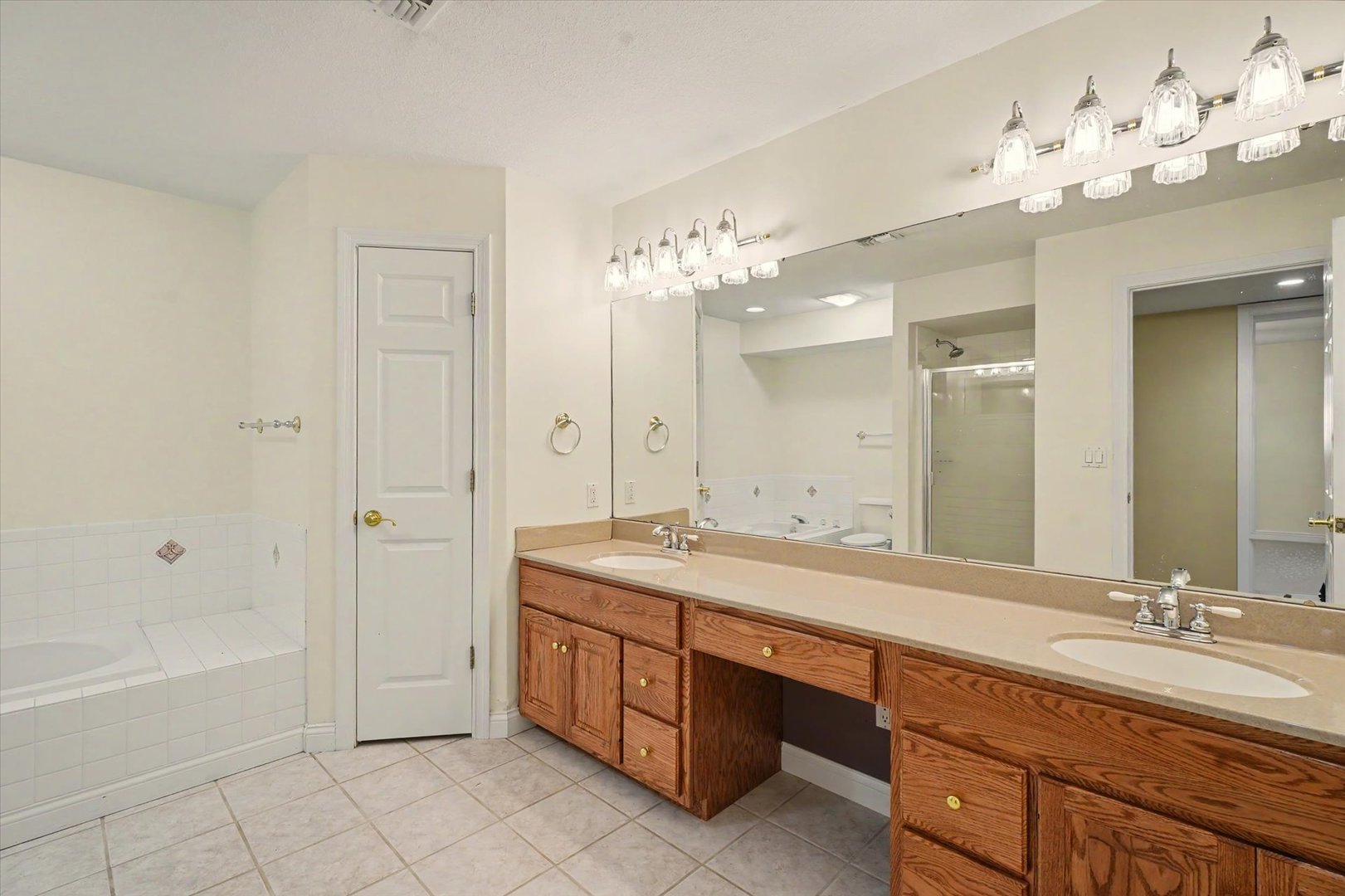 2910 Rutherford Drive Urbana, IL 61802 - Photo 44 of 62 a spacious bathroom with a granite countertop double vanity sink a mirror and a bathtub