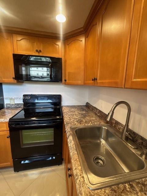 305 Preston F, Unit H Boca Raton, FL 33434 - Photo 12 of 17 a kitchen with granite countertop a stove and a sink