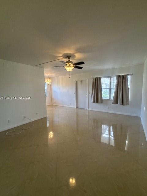 305 Preston F, Unit H Boca Raton, FL 33434 - Photo 15 of 17 a view of a livingroom with a ceiling fan and window
