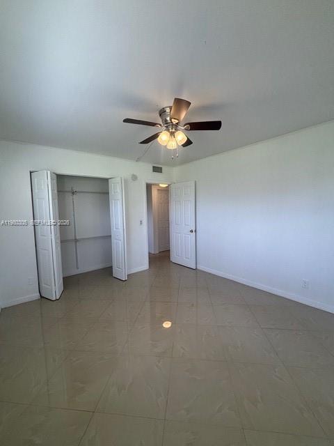 305 Preston F, Unit H Boca Raton, FL 33434 - Photo 2 of 17 an empty room with a ceiling fan and window