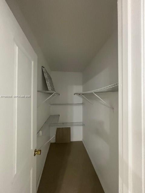 305 Preston F, Unit H Boca Raton, FL 33434 - Photo 6 of 17 a view of walk in closet with empty racks