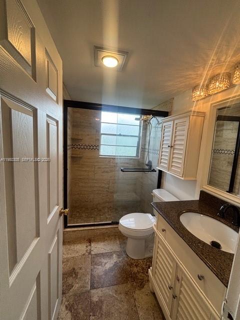 305 Preston F, Unit H Boca Raton, FL 33434 - Photo 7 of 17 a bathroom with a sink toilet a mirror and shower