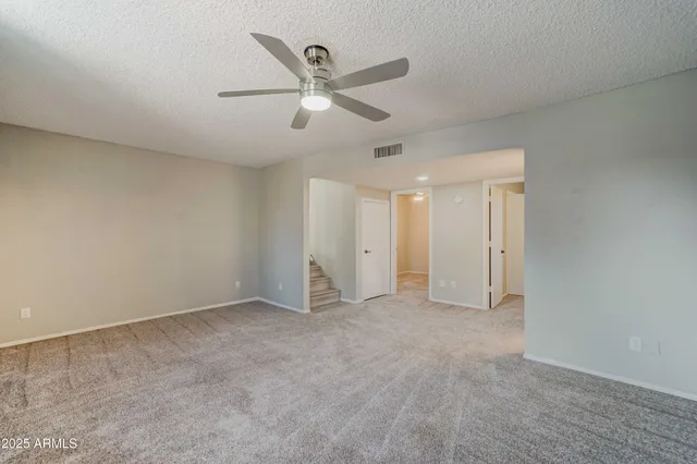 an empty room with closet and fan