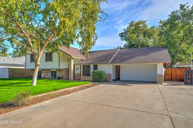 a front view of house with yard and green space