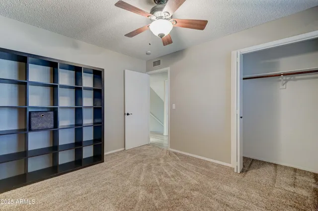 a view of an empty room with a cabinet and a window