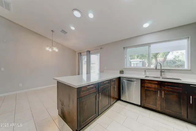 a kitchen with a sink window and cabinets