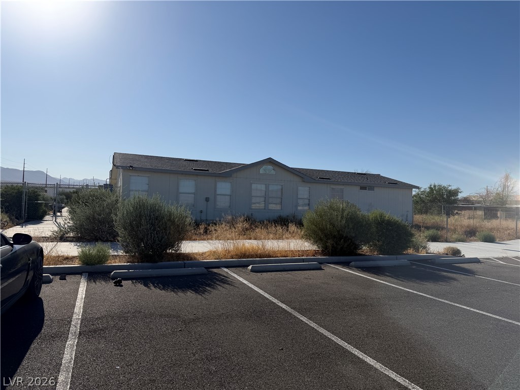 A classic manufactured home offers a welcoming presence with a parking area.