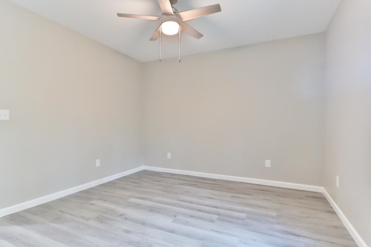 205 Plantation Road Myrtle Beach, SC 29588 - Photo 12 of 35 Spare room with ceiling fan and hardwood / wood-st