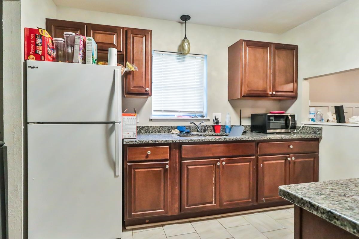 205 Plantation Road Myrtle Beach, SC 29588 - Photo 20 of 35 Kitchen with white refrigerator, dark stone counte